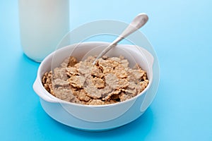 Cereals in white bowl on blue background