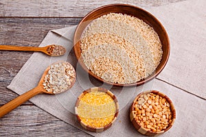 Cereals, on a wooden gray table with burlap.