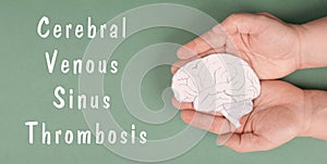 Cerebral Venous Sinus Thrombosis is standing on a paper, hands holding a brain, vaccine damage