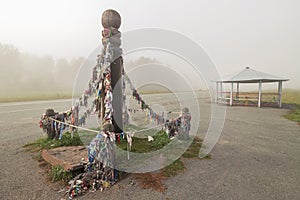 Ceremonial pole with ribbons on the road