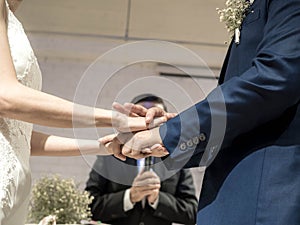 Ceremony of putting on a wedding rings. Mature couple getting married