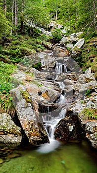 Ceresole Reale, Italy. Small waterfalls between the rocks of a mountain stream, near the Dres waterfall near Lake Ceresole.