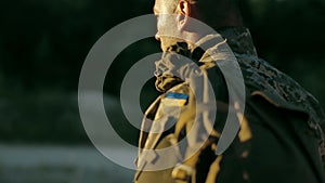 Certain military man walking across sandy road