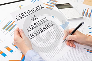 Certificate of liability insurance concept, documents on the desktop