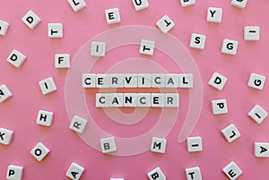 Cervical cancer word made of square letter word on pink background.