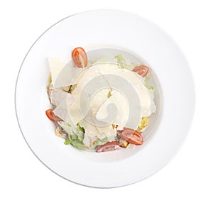 Cesar salad with chicken in a white plate.