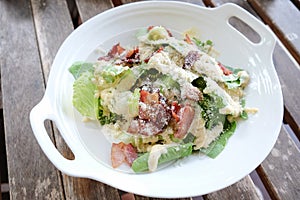 Cesar salad served in white plate
