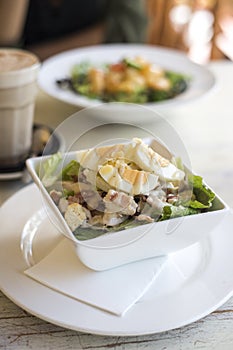 Cesar salad on wooden table