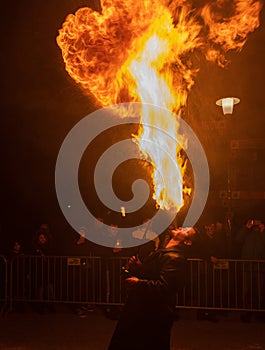 Ceske Budejovice, Czech republic - December 16, 2023: Fireshow man spit fire from mouth on Krampuslauf
