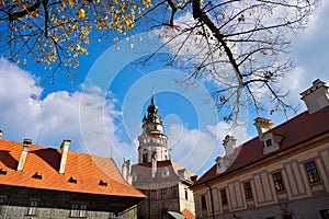 Cesky Krumlov Castle Tower in the daytime of the autumn colors, bright blue sky and beautiful clouds, the old town in europe
