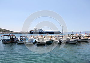 Fishing Boats and A Ferry docked at Cesme Port in Cesme, Turkey