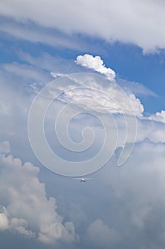 Cessna aircraft flying in the storm cloud and blue sky