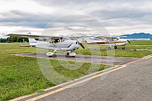 Cessna airplanes parked at a small airport