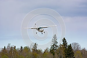 Cessna flies over the runway