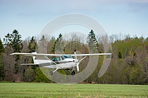 Cessna flies over the runway