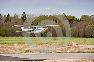 Cessna flies over the runway