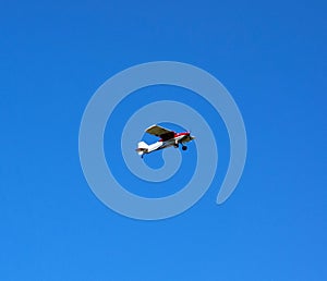 A cessna in flight against a blue sky