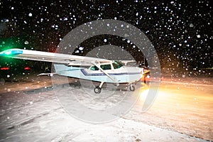 Cessna plane is preparing to fly in a snowstorm