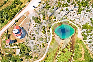 Cetina river source water hole and Orthodox church aerial view