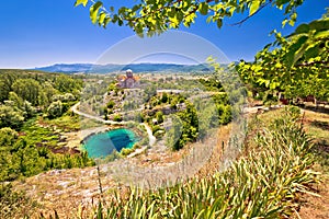 Cetina river source water hole and Orthodox church view