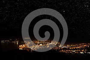 Ceuta city illuminated at night under the stars photo