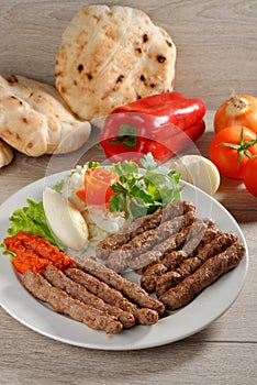 Cevapcici, a small skinless sausage cooked on the barbecue photo