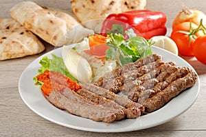 Cevapcici, a small skinless sausage cooked on the barbecue photo