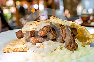 Cevapi with onion and bread photo