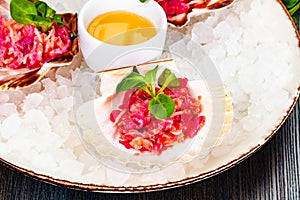 Ceviche. Finely chopped raw tuna and salmon marinated in lemon juice served in seashell