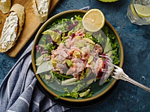 Ceviche is a traditional dish from Peru. Salmon marinated in lemon with fresh lettuce, avocado and onions