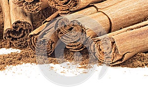 Ceylon cinnamon sticks and cinnamon powder on white background, close up