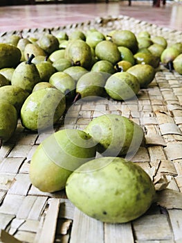 Ceylon Olive (Veralu) fruits in a traditional reed mat