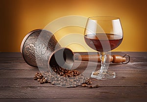 Cezve with coffee beans and glass of whiskey