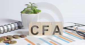 CFA text on wooden blocks business concept graph background