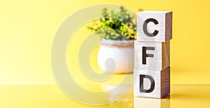 CFD abbreviation - Contract For Difference, on wooden cubes on a light background