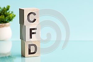 CFD abbreviation - Contract For Difference, on wooden cubes on a light background