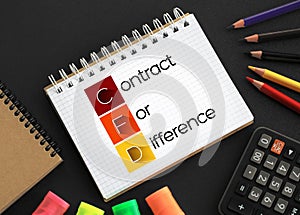 CFD - Contract For Difference acronym on notepad, business concept background