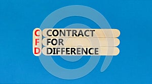 CFD symbol. Concept words CFD contract of difference on beautiful wooden sticks. Beautiful blue table blue background. Business