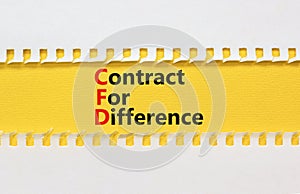 CFD symbol. Concept words CFD contract of difference on beautiful yellow paper. Beautiful white table white background. Business