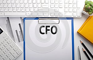 CFO written on paper with keyboard, chart, calculator and notebook