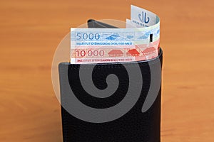 CFP franc in the black wallet