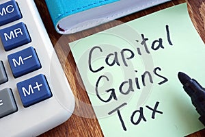 CGT Capital Gains Tax. Memo stick and calculator.