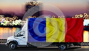 Chad flag on the side of a white van against the backdrop of a blurred city and river. Logistics concept