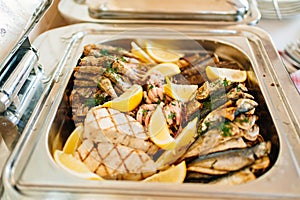 Chafing Dish with assorted grilled fish.