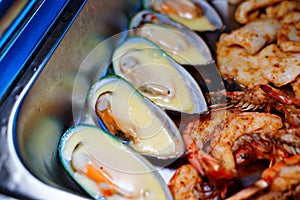 Chafing Dish with assorted grilled mussels and shrimps