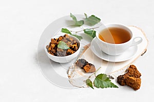 Chaga tea on a white background. Useful infusion of birch mushrooms. Drink to boost immunity