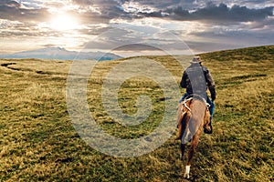 cowboys riding on the moors of Cotopaxi National Park, Equador photo