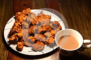 Chai with pakoras and bhajiyas served on plate