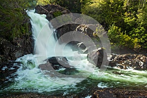 Chaicas river waterfall between forest and rocks photo