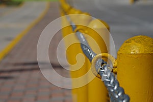 Chain along a yellow post line on a street